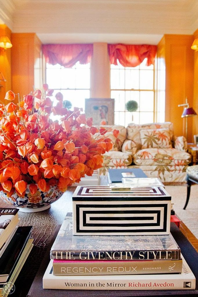 Living room with orange theme and Chinese Lantern bouquet.